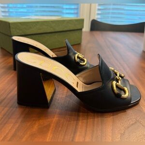 GUCCI black and gold horse bit slide heels